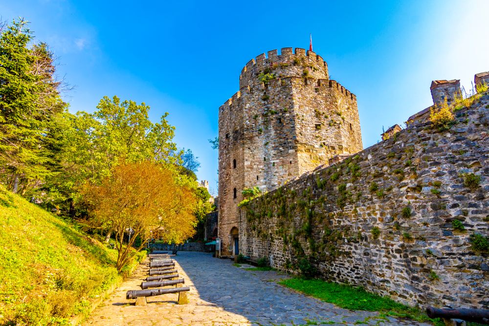 Rumeli Fortress stone towers rising above the Bosphorus shoreline in Istanbul