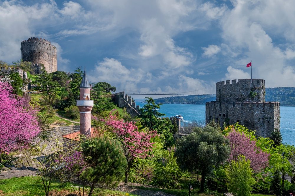Rumeli Fortress towers under dramatic sky with Bosphorus in the background